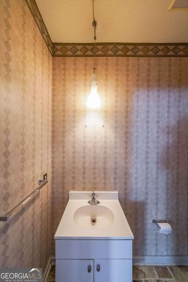 bathroom featuring vanity and a textured ceiling