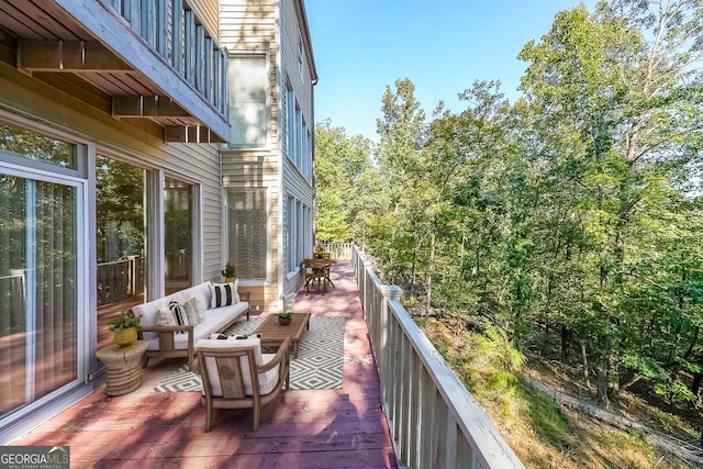 wooden balcony with an outdoor hangout area and a deck