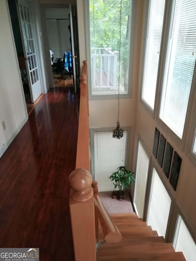 hallway with a chandelier and hardwood / wood-style flooring