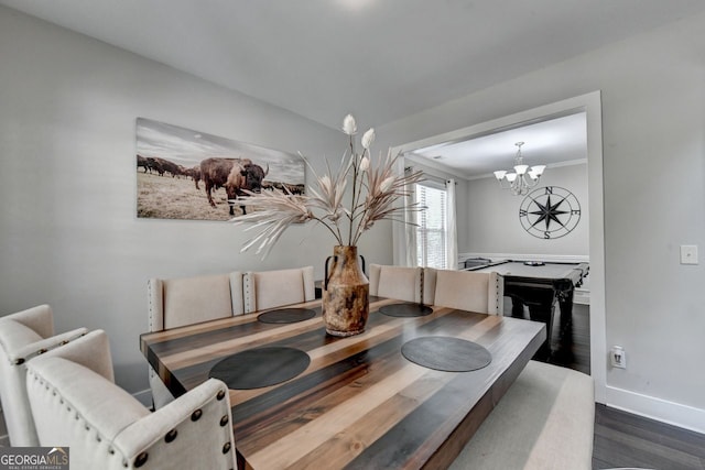 dining space with crown molding, an inviting chandelier, and dark hardwood / wood-style flooring