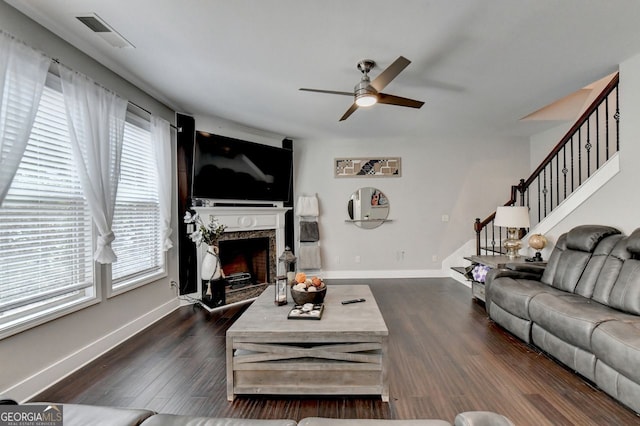 living room with ceiling fan and dark wood-type flooring