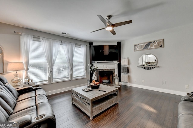 living room featuring ceiling fan and dark hardwood / wood-style flooring