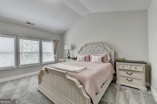 carpeted bedroom featuring lofted ceiling