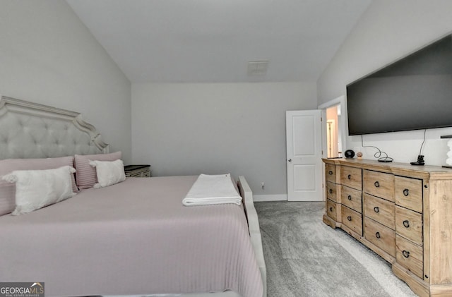 bedroom featuring light colored carpet and vaulted ceiling