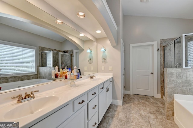 bathroom featuring vanity, lofted ceiling, and separate shower and tub