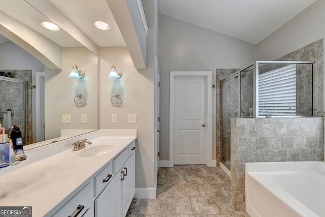 bathroom with independent shower and bath, vanity, and lofted ceiling