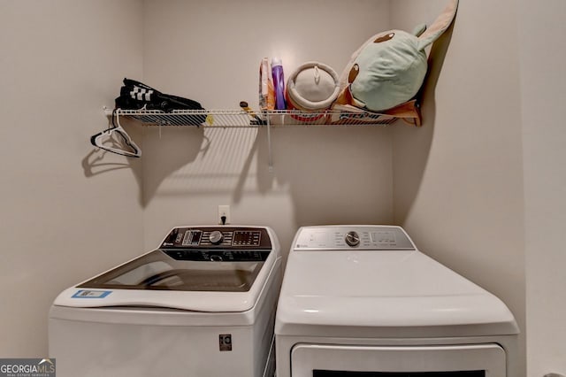 clothes washing area featuring washing machine and clothes dryer