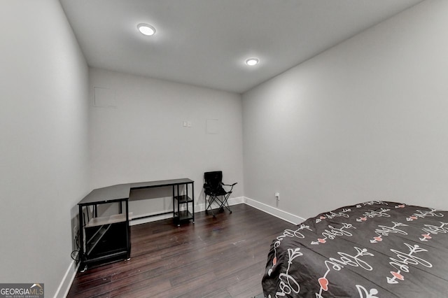 bedroom with dark hardwood / wood-style floors