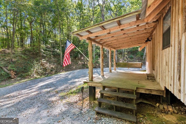 exterior space featuring gravel driveway and a deck