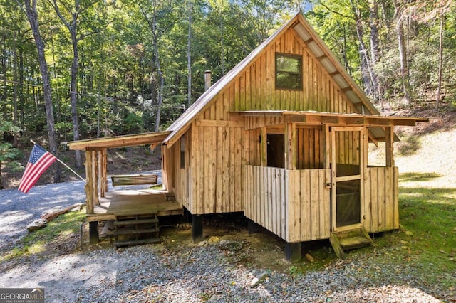 view of outbuilding with an outbuilding and a wooded view