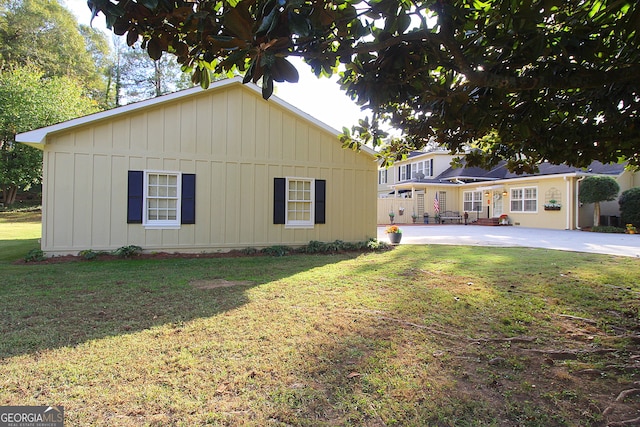 back of property featuring a yard