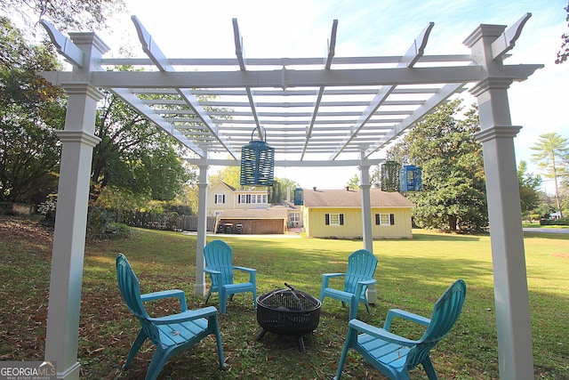 view of yard with a hot tub, a fire pit, and a pergola