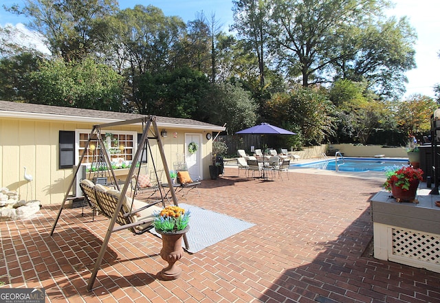 view of swimming pool with a patio area