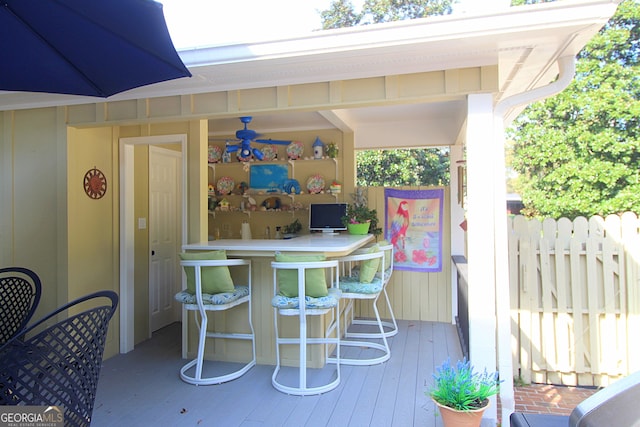 wooden terrace featuring exterior bar