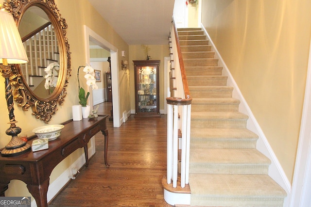 stairs featuring wood-type flooring