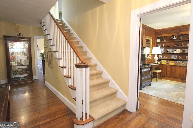 stairs with hardwood / wood-style floors