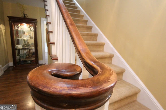 stairs with hardwood / wood-style flooring