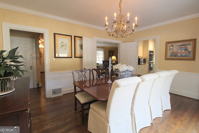 dining space with ornamental molding, dark wood-type flooring, and a chandelier