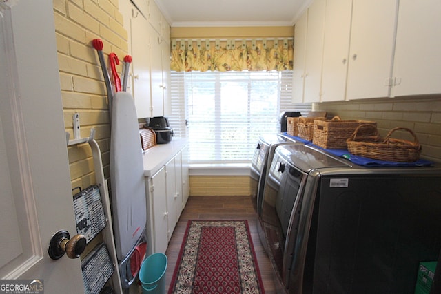 laundry area with cabinets, washer and dryer, crown molding, and dark hardwood / wood-style flooring