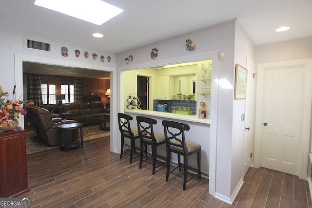 kitchen featuring wooden walls and dark hardwood / wood-style flooring