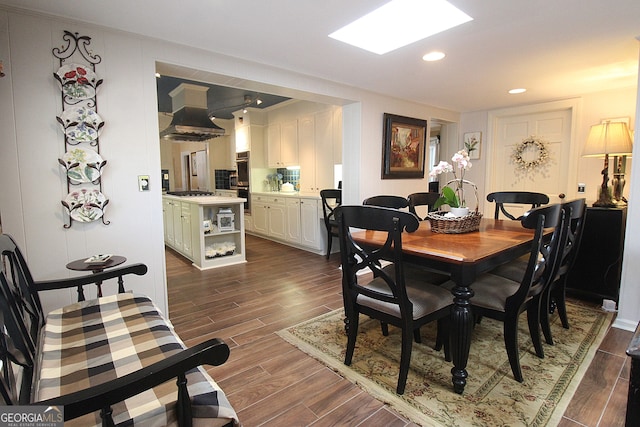 dining space featuring dark wood-type flooring