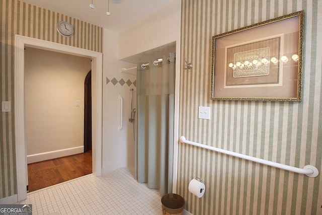 bathroom featuring tile patterned floors and tiled shower