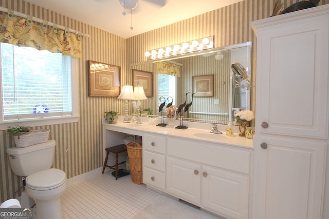 bathroom featuring ceiling fan, vanity, tile patterned floors, and toilet