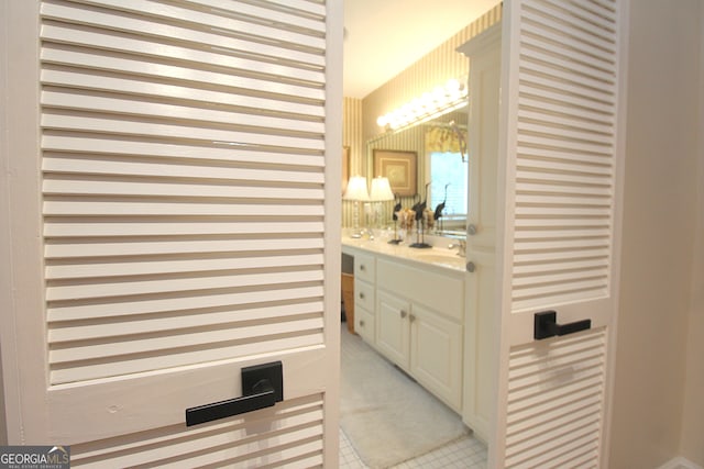 bathroom with tile patterned flooring and vanity