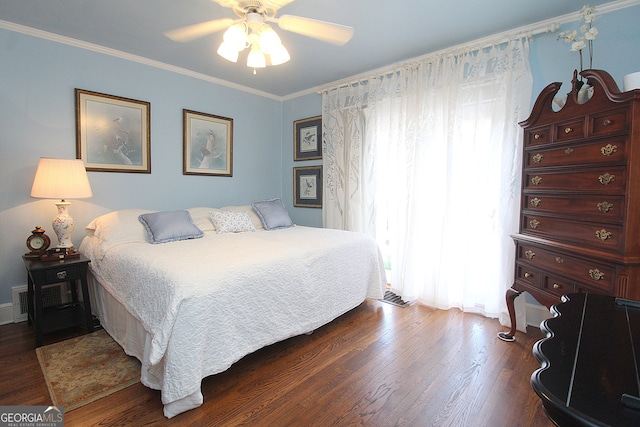 bedroom with ceiling fan, wood-type flooring, multiple windows, and ornamental molding