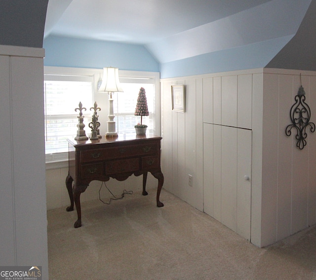 carpeted office with vaulted ceiling