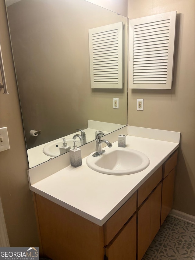 bathroom featuring tile patterned flooring and vanity