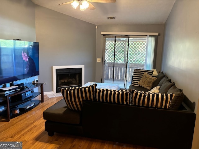 living room featuring hardwood / wood-style flooring and ceiling fan