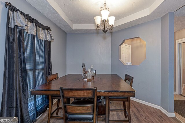 dining space featuring hardwood / wood-style floors and a notable chandelier