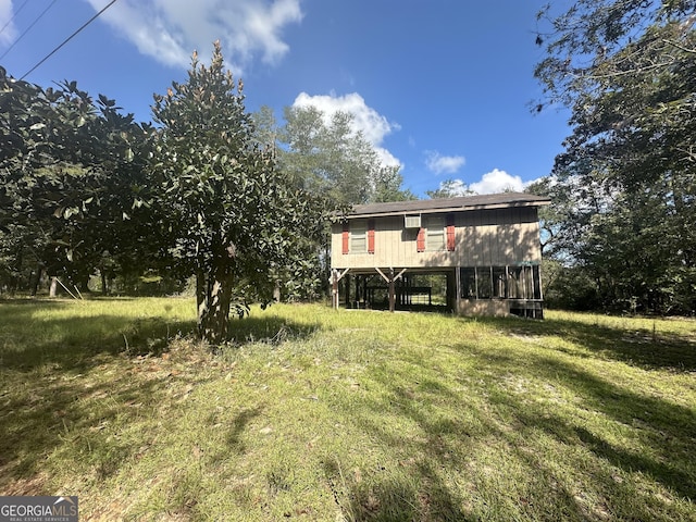 back of property featuring a lawn