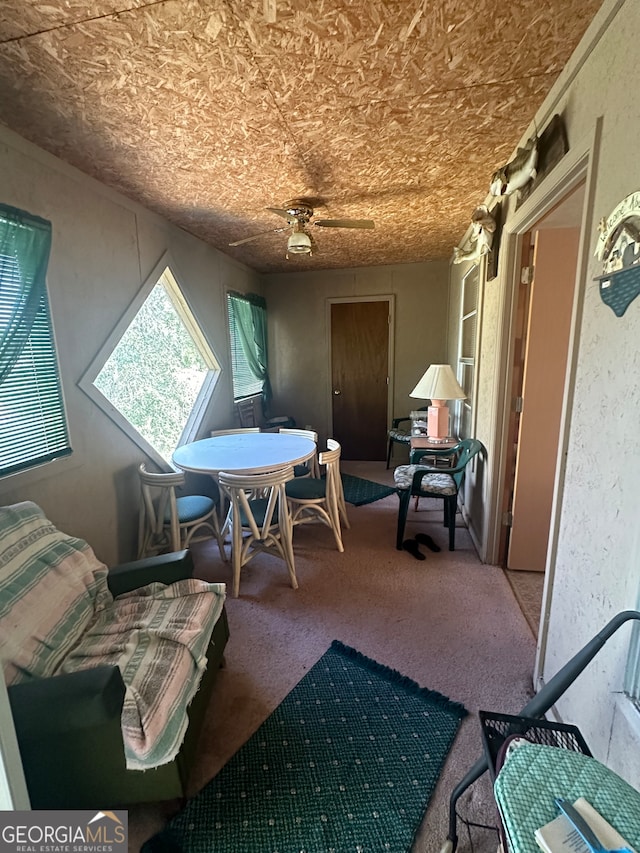 sitting room with ceiling fan and carpet