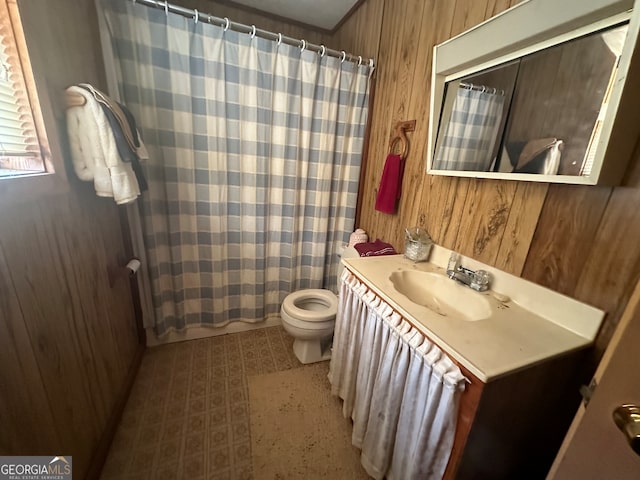 bathroom with toilet, wood walls, vanity, and walk in shower