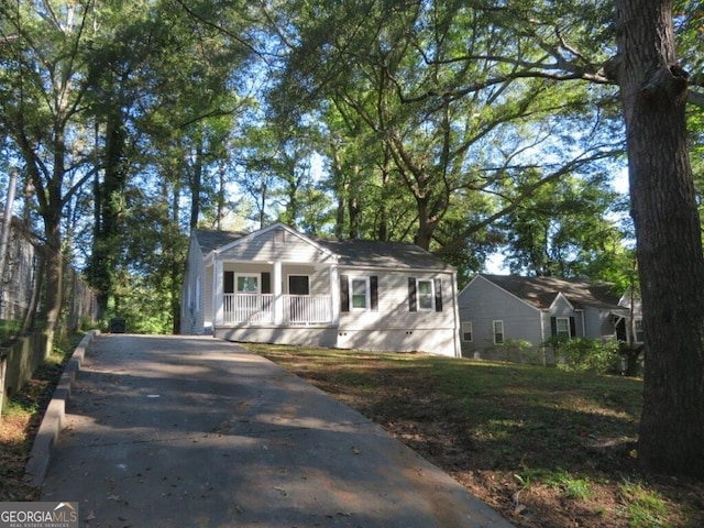 bungalow with driveway, a porch, and crawl space