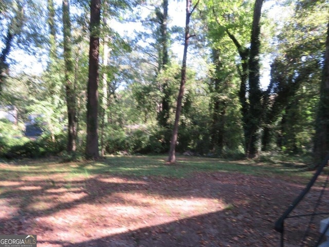 view of yard with a forest view