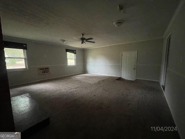 carpeted empty room featuring ceiling fan and crown molding