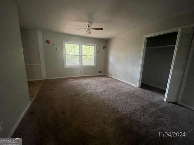 unfurnished bedroom featuring ceiling fan and carpet floors