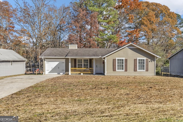 single story home with covered porch, a garage, and a front yard