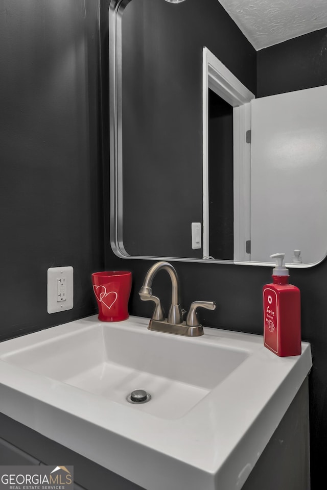 bathroom with sink and a textured ceiling