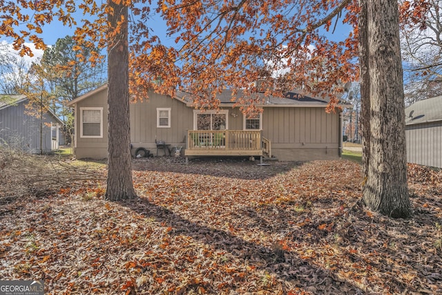 rear view of property featuring a deck