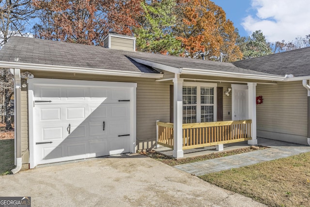 view of front facade featuring covered porch and a garage