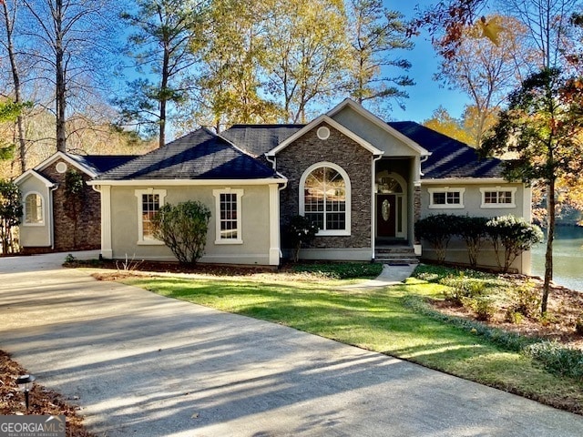 ranch-style home with a front lawn