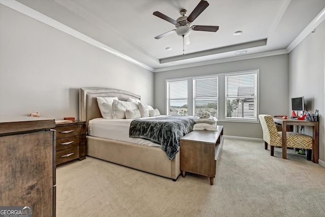 carpeted bedroom with crown molding, ceiling fan, and a tray ceiling