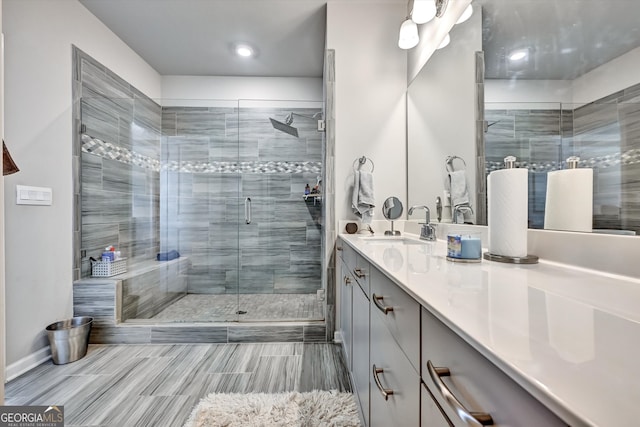 bathroom with walk in shower and vanity