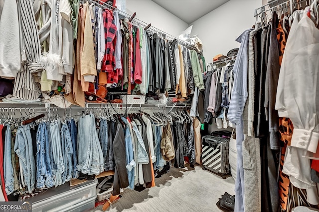 walk in closet with carpet