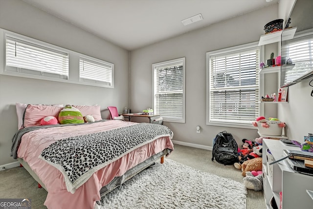 bedroom with carpet flooring and multiple windows