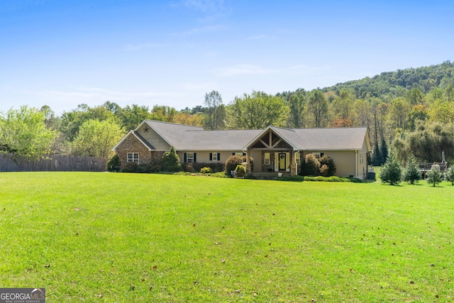 single story home featuring a front lawn